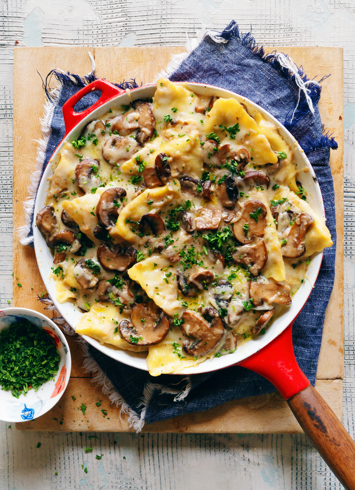 Overhead view of one-skillet chicken tortellini topped with parmesan and fresh herbs