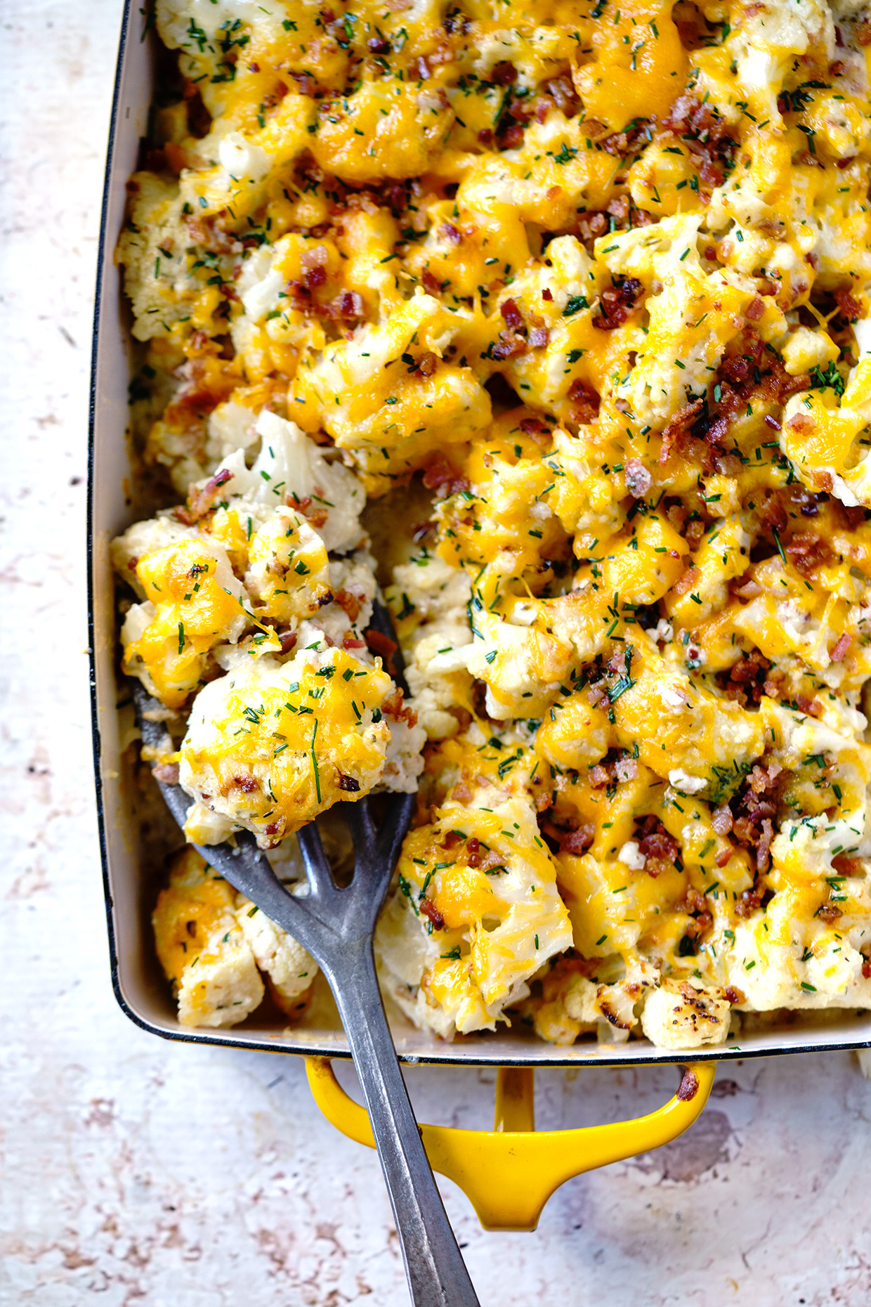 Loaded Cauliflower Bake ~ Think your favorite baked potato in cauliflower form and loaded with cheesy goodness, crumbled bacon and chives. 