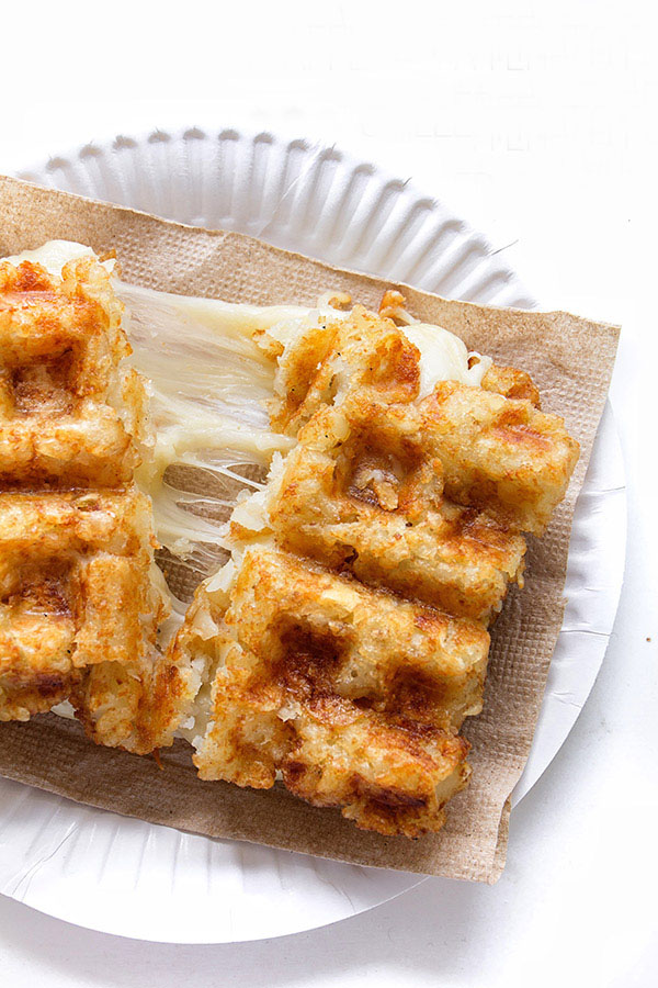 Close-up of grilled cheese made with waffle-pressed tater tots, showing crispy texture and melted cheese inside